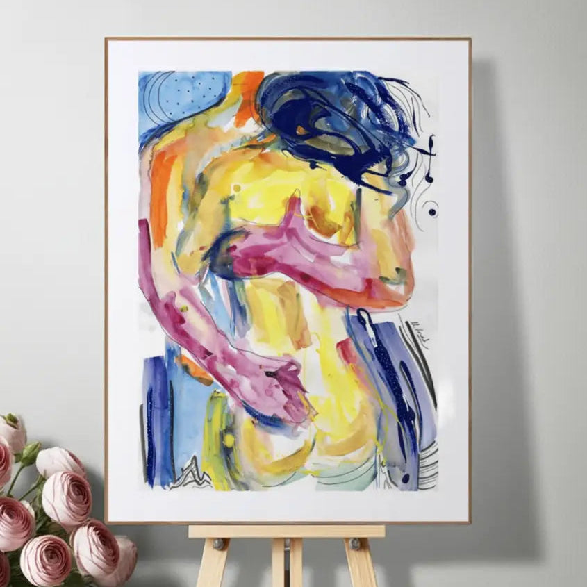 Colorful abstract painting on a white frame displayed on an easel with pink roses beside it.