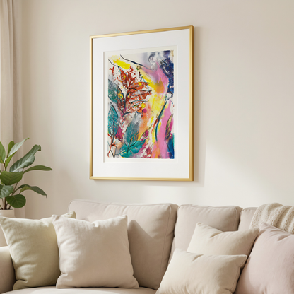 Colorful abstract painting in a gold frame on a wall above a beige sofa.