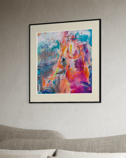 A framed abstract painting featuring a colorful female figure in a vibrant mix of pink, orange, blue, and purple tones, displayed on a textured light gray wall above a modern gray sofa.