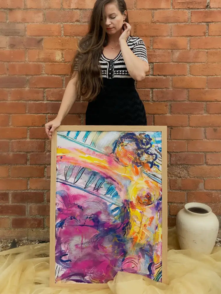 a woman holding an abstract colour painting 