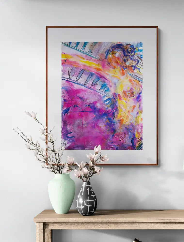 Abstract painting of figure woman  framed and hanging on a wall above a table with flowers 