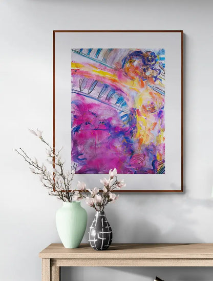 Abstract painting of figure woman  framed and hanging on a wall above a table with flowers 
