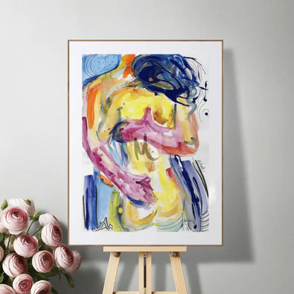 Colorful abstract painting on a white frame displayed on an easel with pink roses beside it.