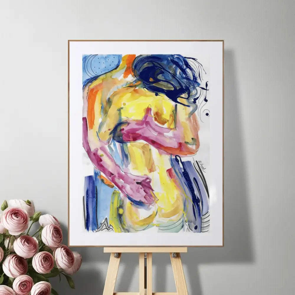 Colorful abstract painting on a white frame displayed on an easel with pink roses beside it.