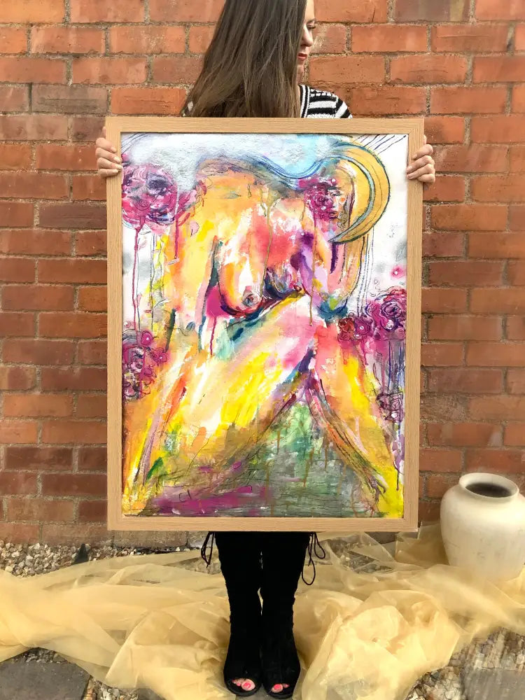 a woman holding abstract painting 