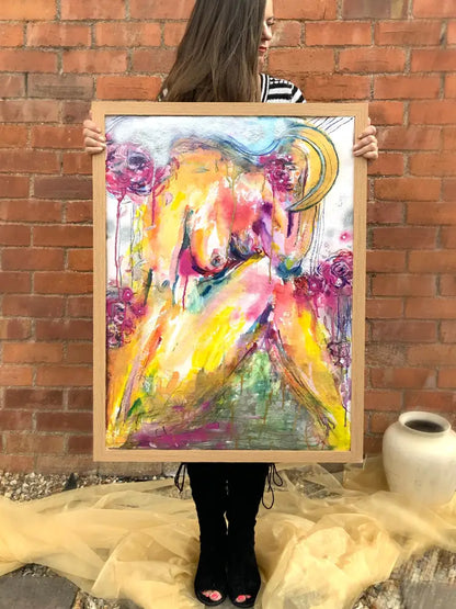 a woman holding abstract painting 