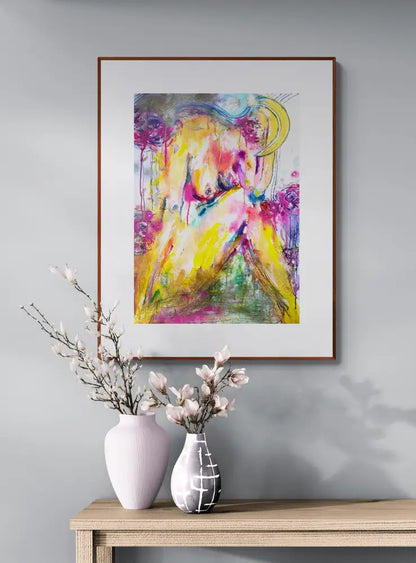 Framed abstract painting on a wall above a wooden console table with decorative vases.