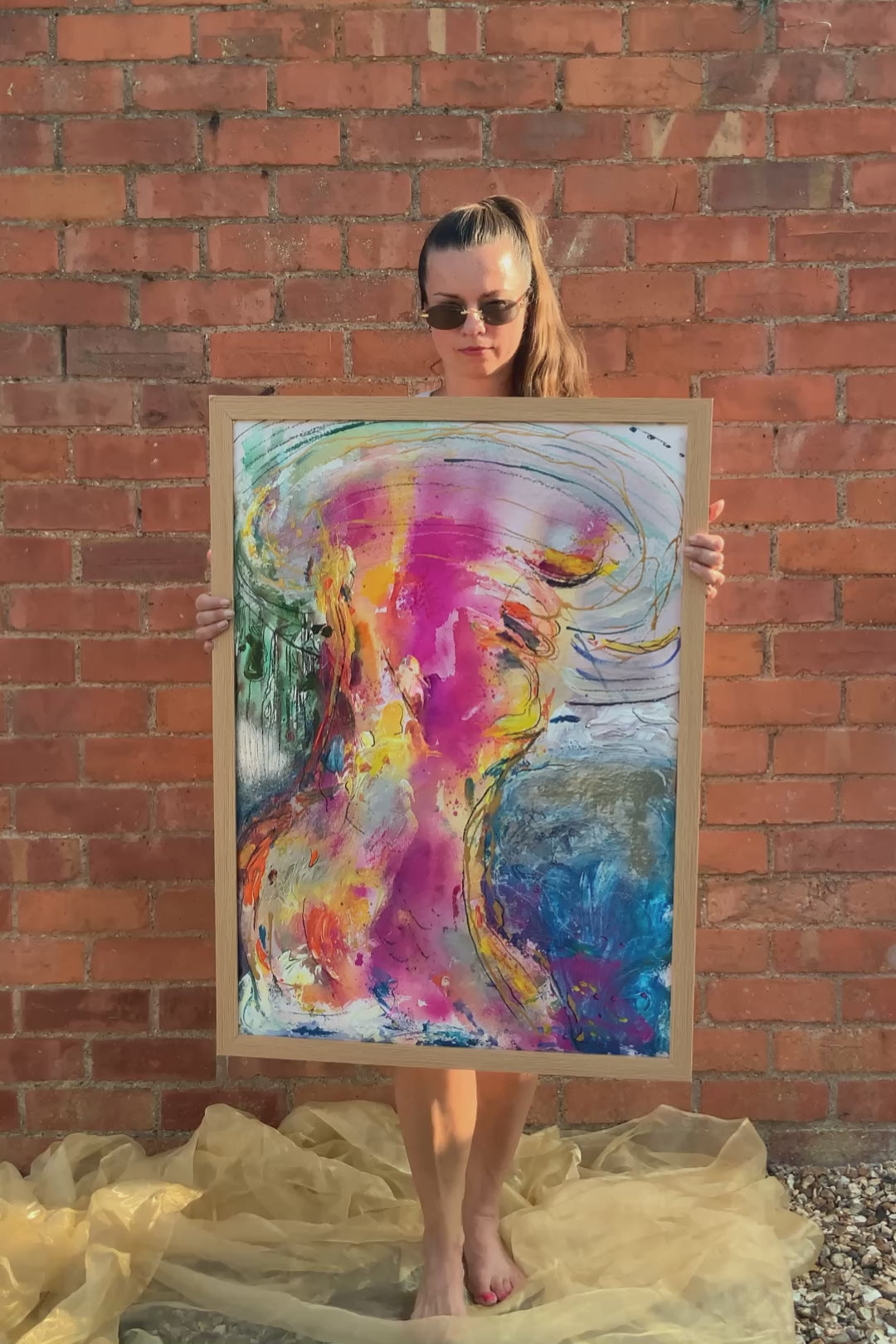 woman holding abstract woman painting art wall