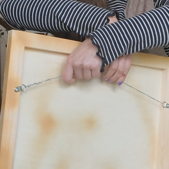 beautiful woman holding abstract paintings for sale