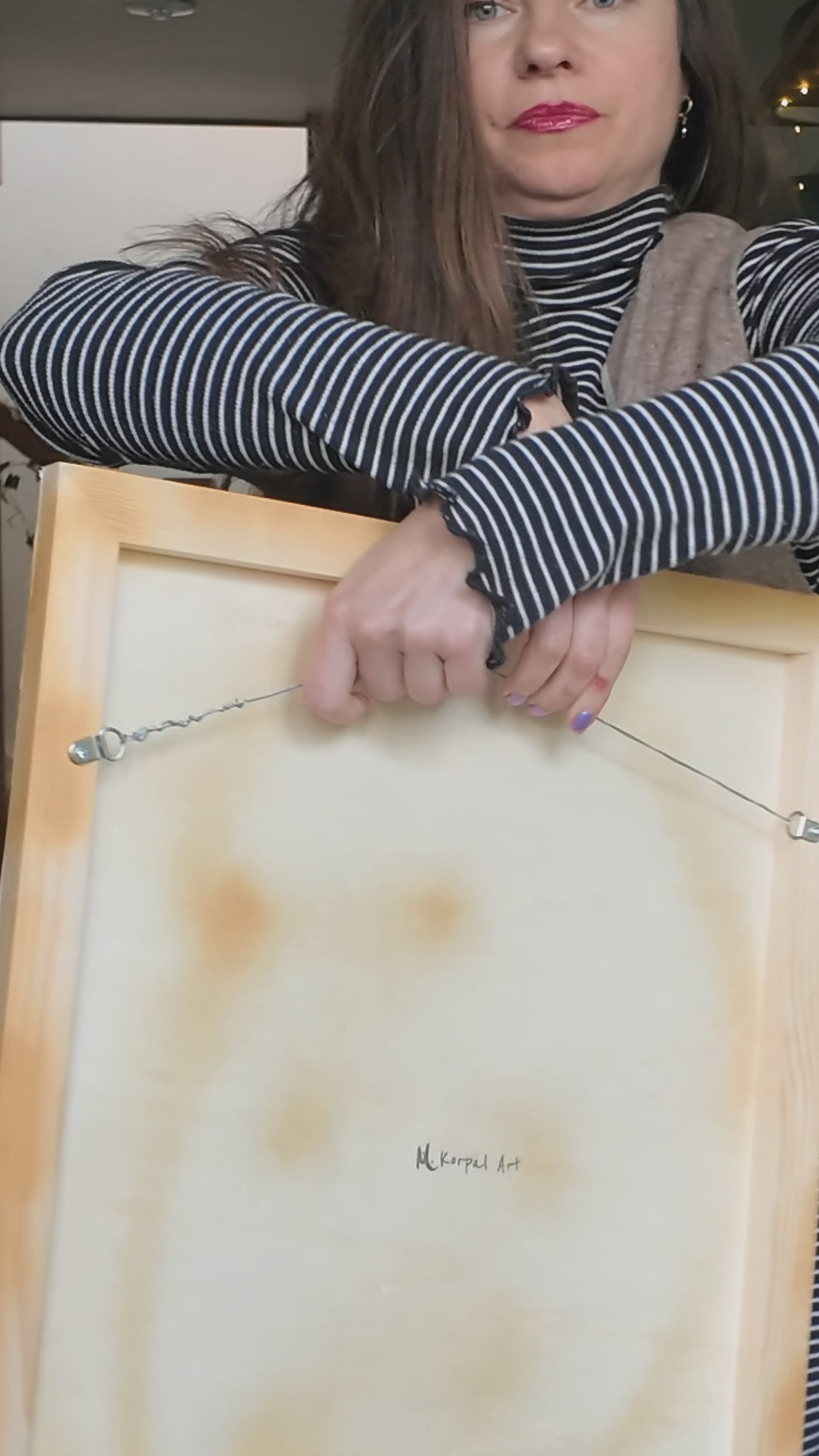 beautiful woman holding abstract paintings for sale