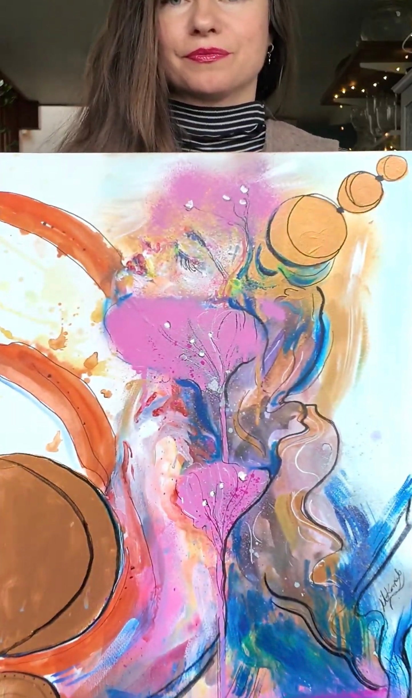 woman showing her abstract painting for sale